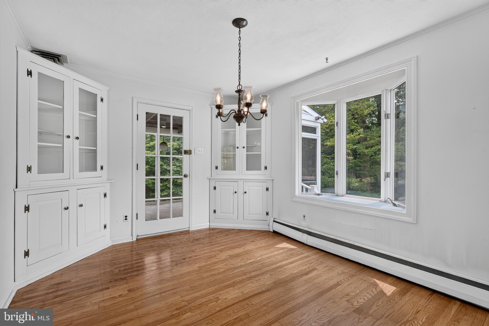 1408 Ponds Edge Road West Chester, PA 19382 - Photo 21 of 53 an empty room with wooden floor exposed radiator and windows
