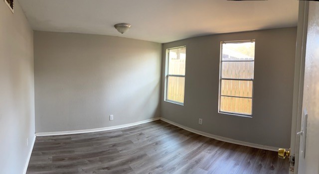 4042 Loop 1781 Rockport, TX 78382 - Photo 17 of 33 an empty room with wooden floor and windows