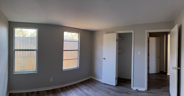 4042 Loop 1781 Rockport, TX 78382 - Photo 18 of 33 an empty room with wooden floor and windows