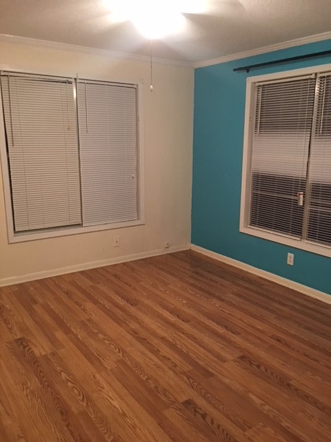 4042 Loop 1781 Rockport, TX 78382 - Photo 9 of 33 an empty room with wooden floor and windows