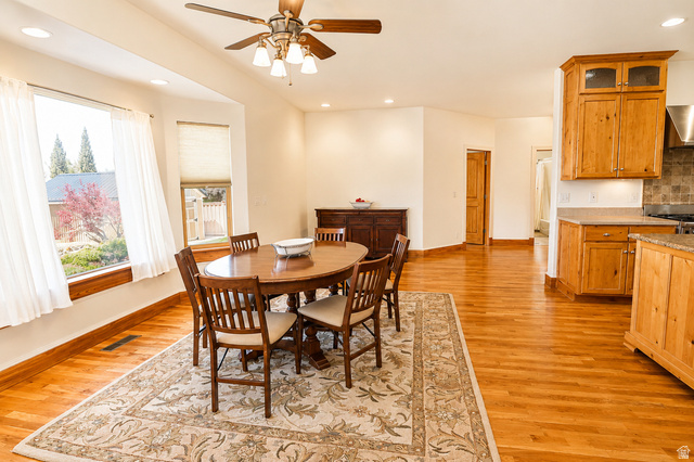 1055 North 1000 East Mapleton, UT 84664 - Photo 25 of 112 Open-concept dining area featuring wood-finish flooring, a bay window with natural wood trim, recessed lighting, and a ceiling fan