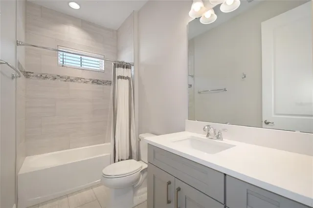 an empty room with chandelier fan