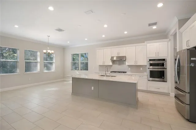 a kitchen with a refrigerator a sink and a stove
