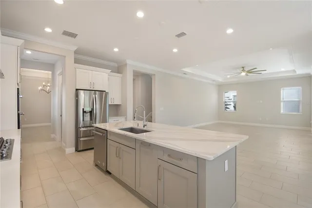 a large kitchen with kitchen island a sink stainless steel appliances and cabinets