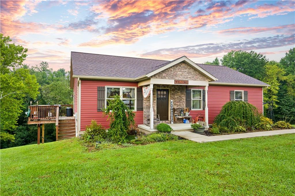 418 Shagbark Road Grindstone, PA 15442 - Photo 1 of 20 a front view of a house with a yard table and chairs