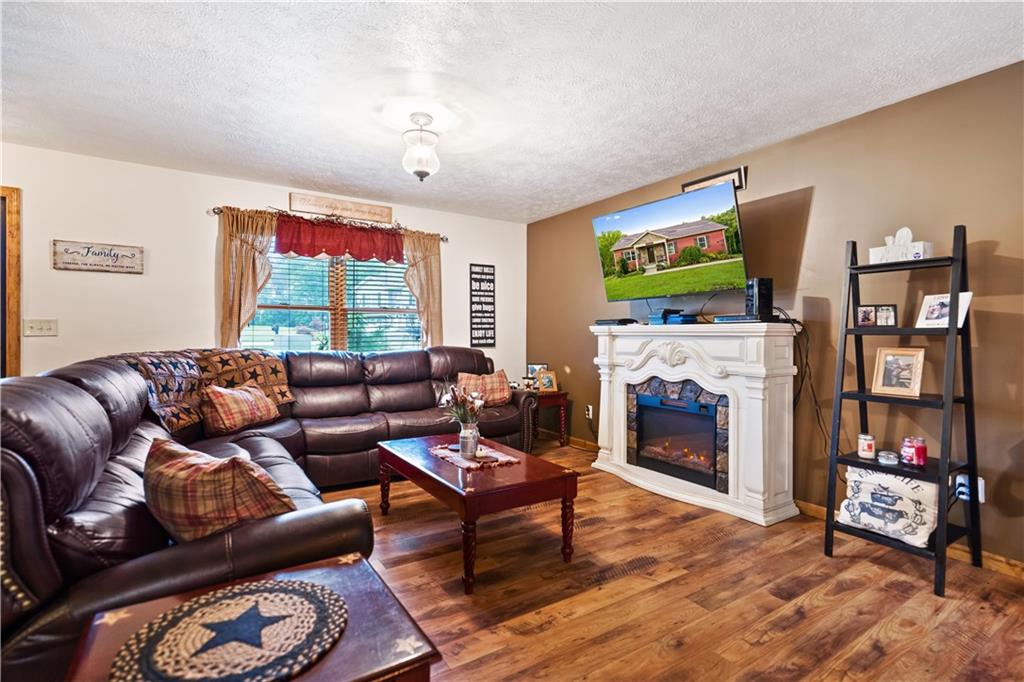 418 Shagbark Road Grindstone, PA 15442 - Photo 3 of 20 a living room with fireplace furniture and a flat screen tv