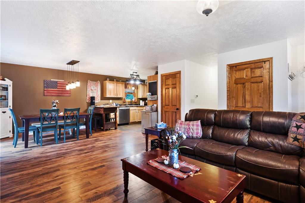 418 Shagbark Road Grindstone, PA 15442 - Photo 4 of 20 a living room with furniture kitchen view and a wooden floor