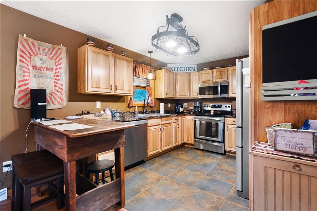 418 Shagbark Road Grindstone, PA 15442 - Photo 6 of 20 a kitchen with a stove and a refrigerator