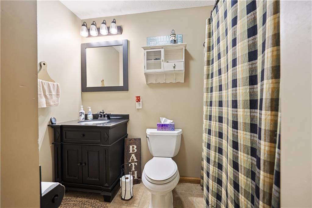 418 Shagbark Road Grindstone, PA 15442 - Photo 8 of 20 a bathroom with a granite countertop toilet sink and mirror