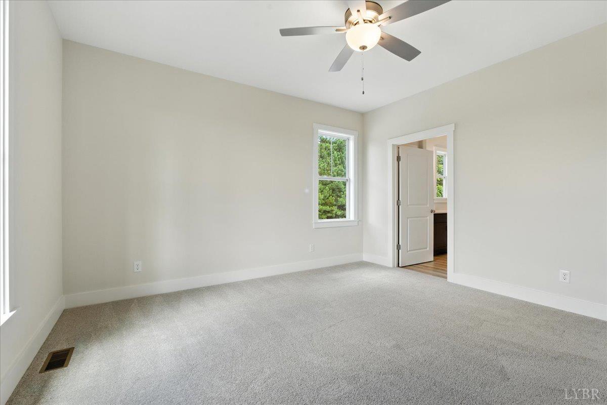 2140 Bent Creek Road Concord, VA 24538 - Photo 22 of 35 an empty room with chandelier fan and windows