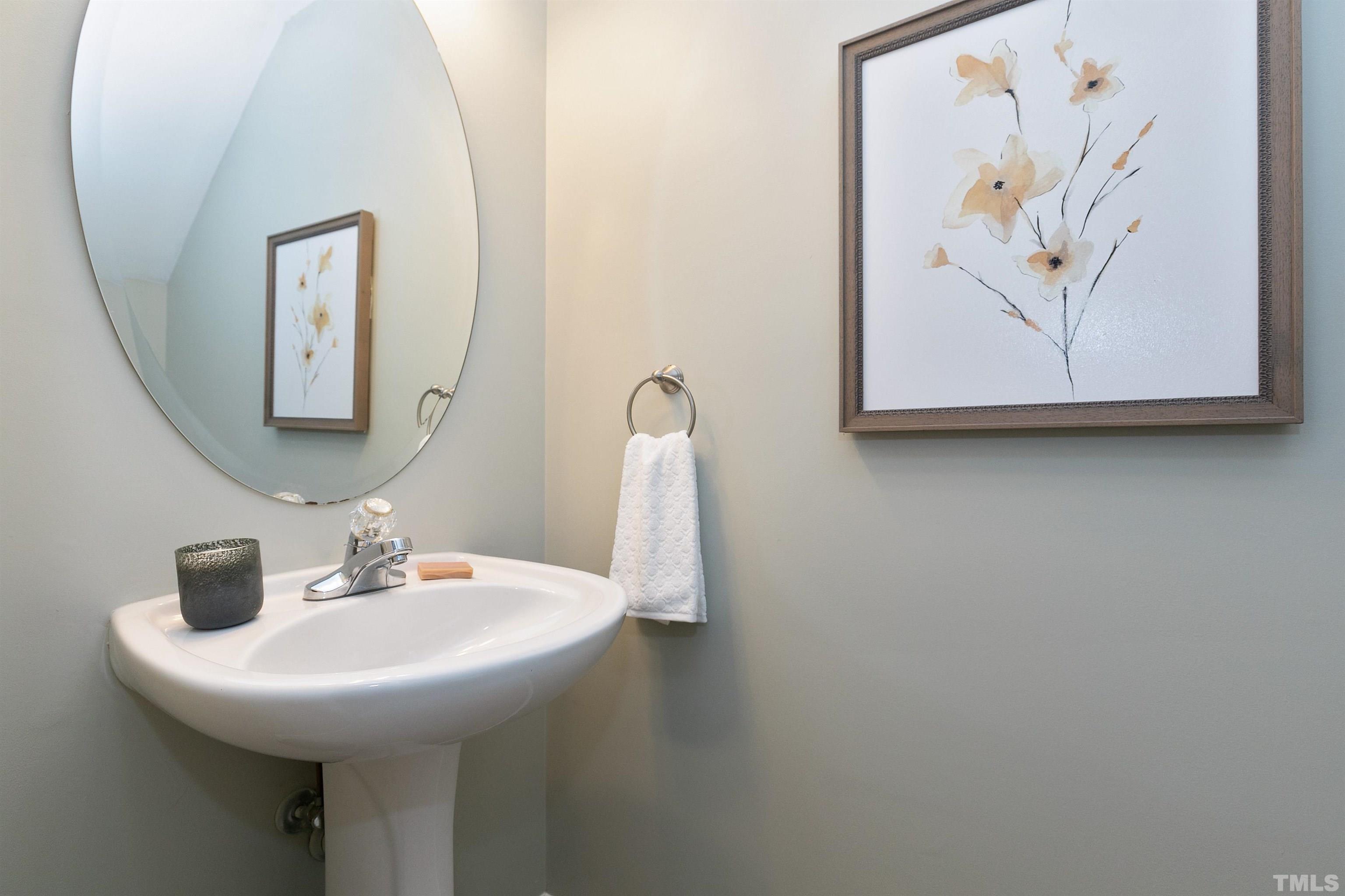9909 Layla Avenue Raleigh, NC 27617 - Photo 14 of 30 a bathroom with a sink and mirror