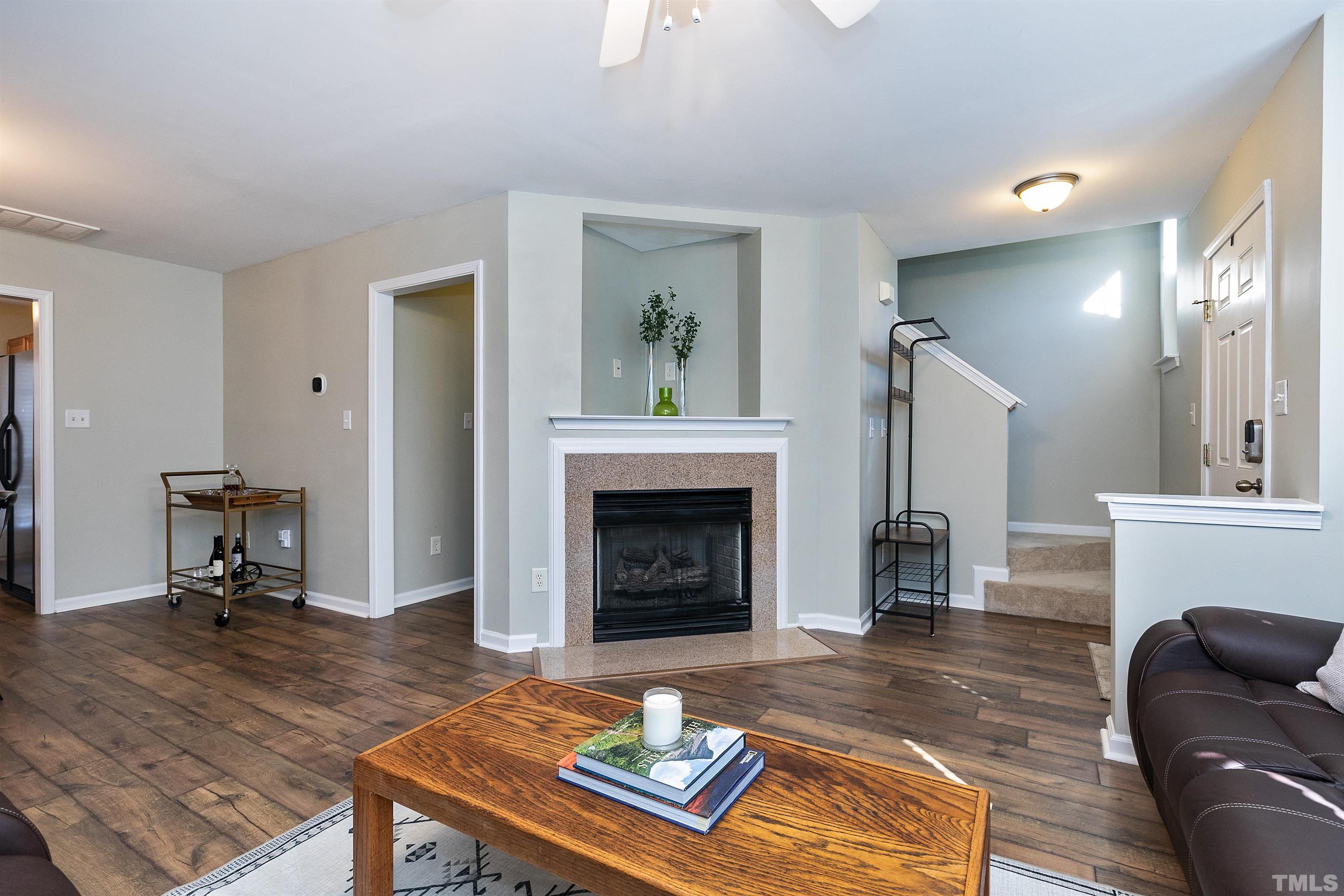 9909 Layla Avenue Raleigh, NC 27617 - Photo 8 of 30 a living room with furniture and a fireplace