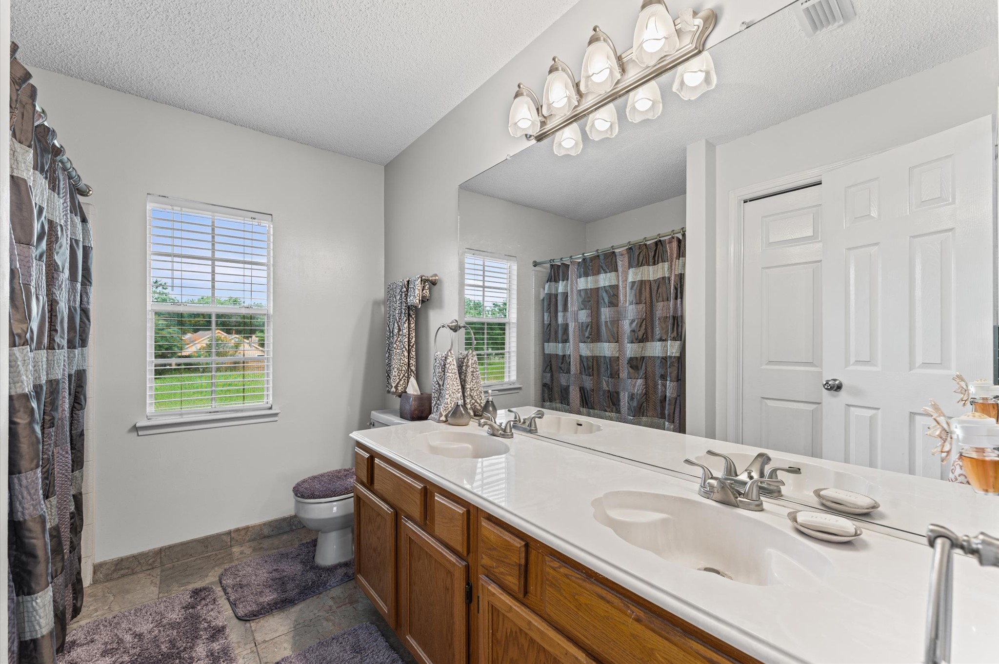 9903 Burntfork Street Houston, TX 77064 - Photo 16 of 25 Secondary bathroom with double sinks.