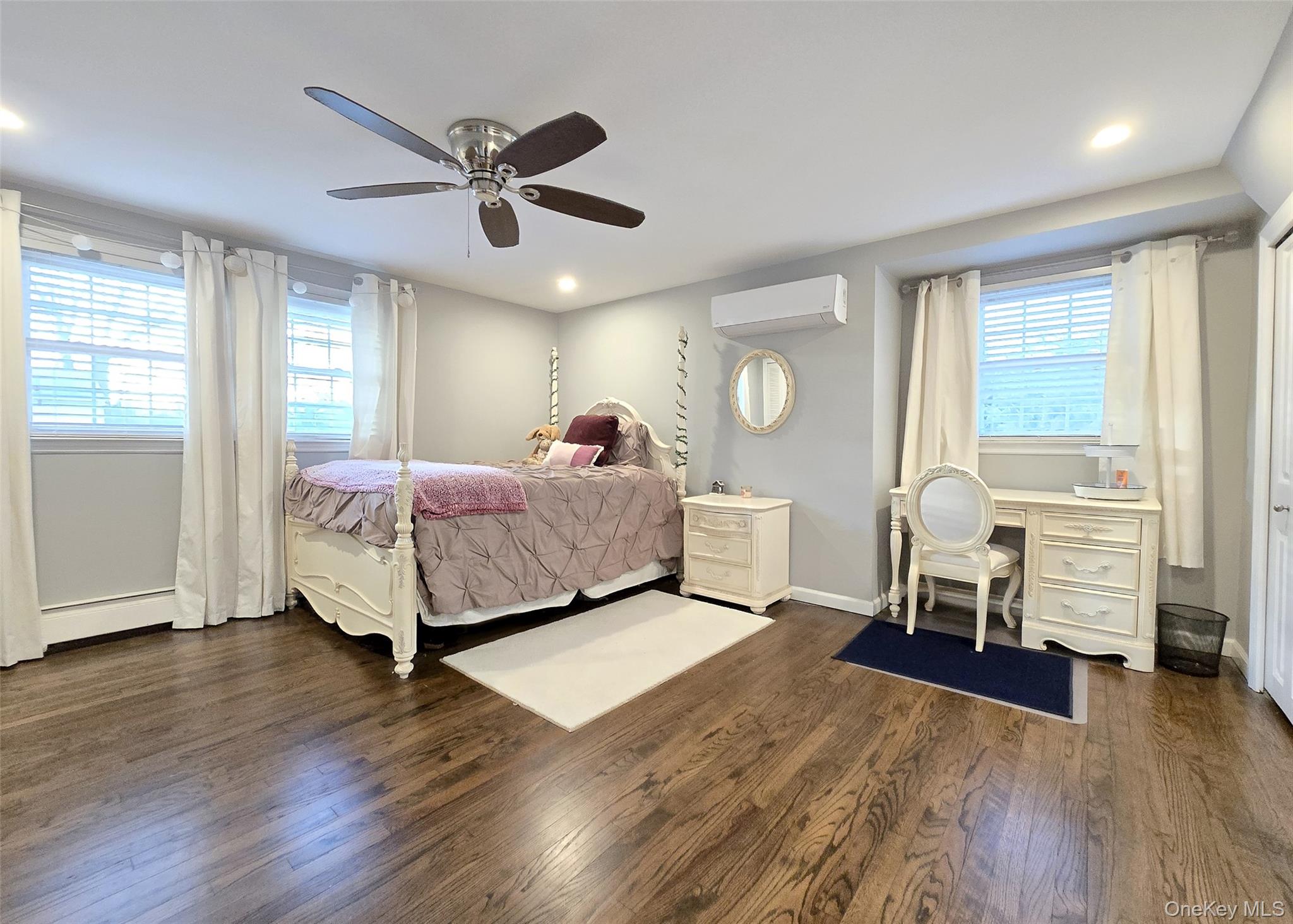 94 Clarendon Road Ronkonkoma, NY 11779 - Photo 12 of 31 a bedroom with a bed and a table in it