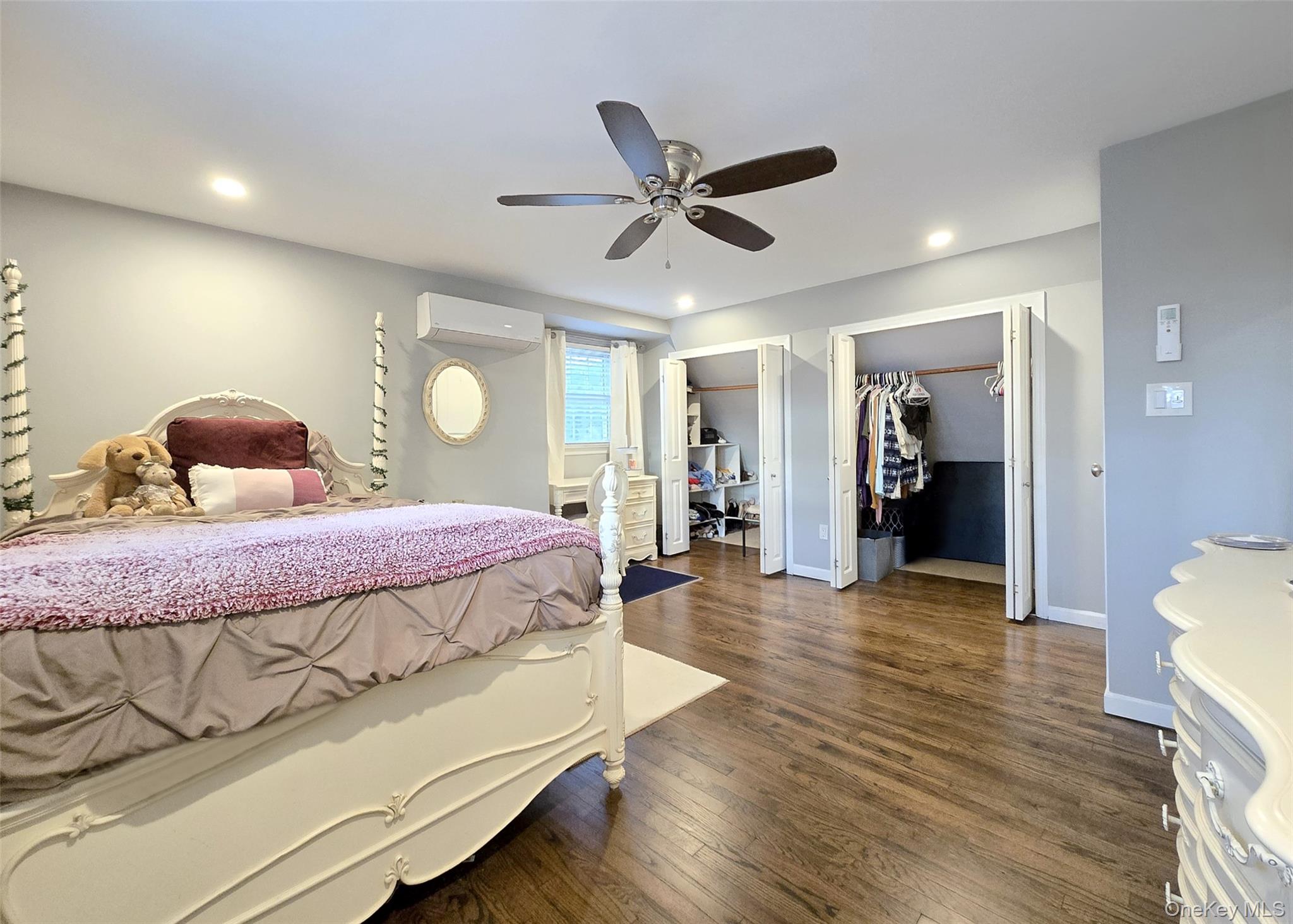 94 Clarendon Road Ronkonkoma, NY 11779 - Photo 13 of 31 a bedroom with a bed and wooden floor