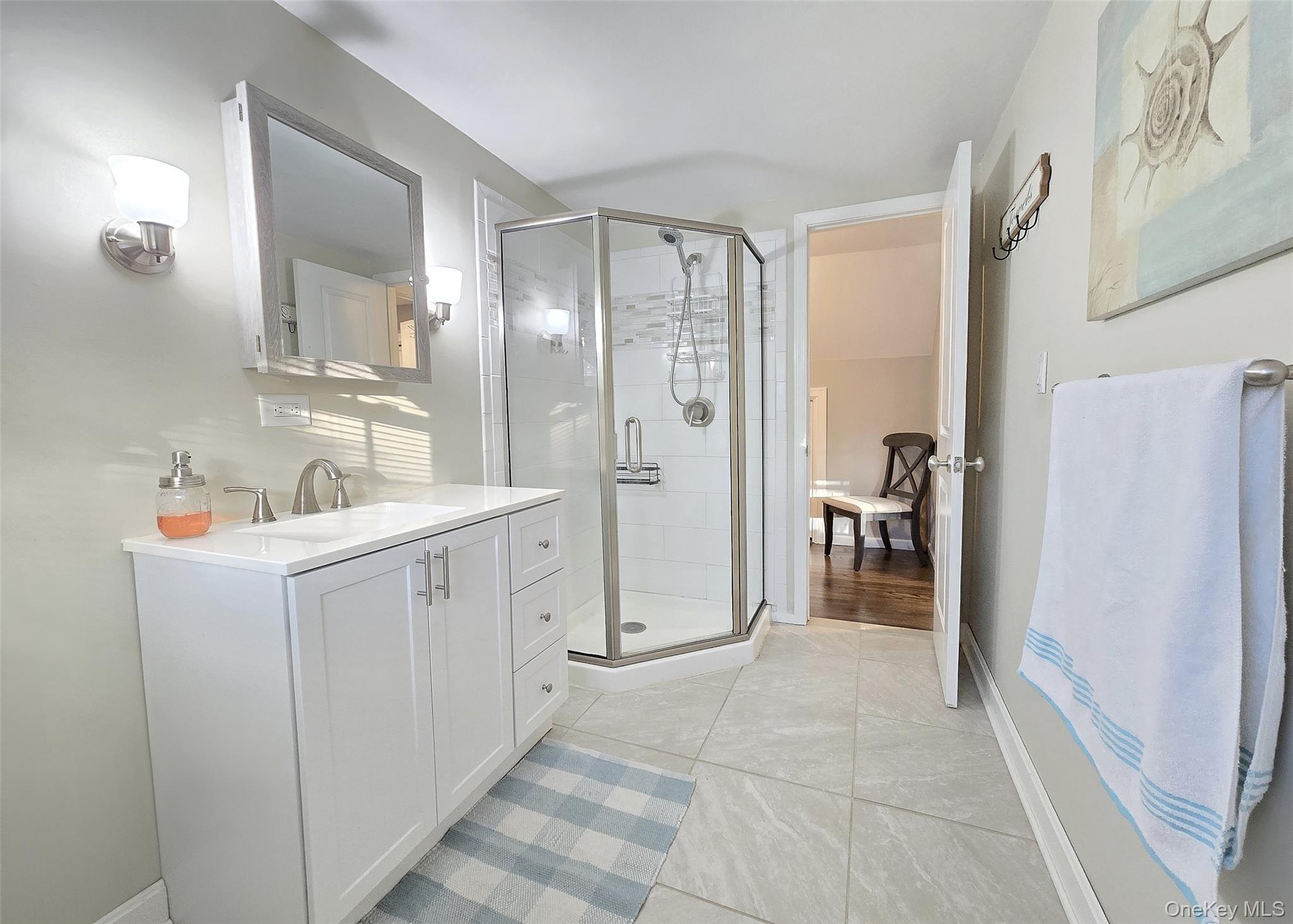 94 Clarendon Road Ronkonkoma, NY 11779 - Photo 14 of 31 a bathroom with a sink a mirror and a shower