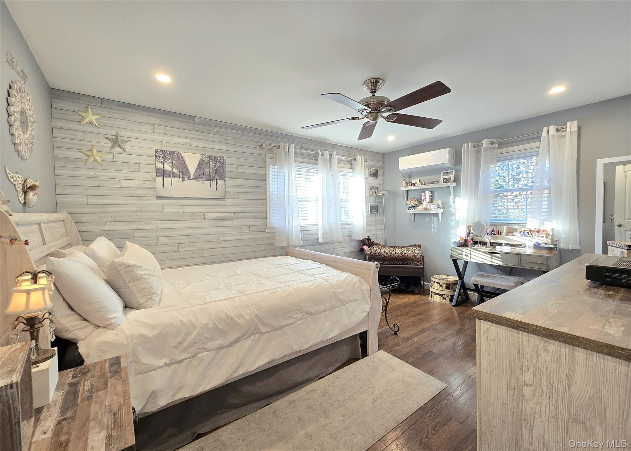 94 Clarendon Road Ronkonkoma, NY 11779 - Photo 16 of 31 a bedroom with a bed a couch and a chandelier