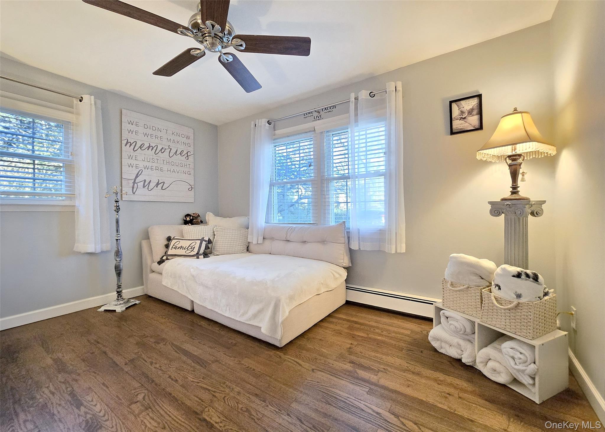 94 Clarendon Road Ronkonkoma, NY 11779 - Photo 18 of 31 a bedroom with a bed and wooden floor