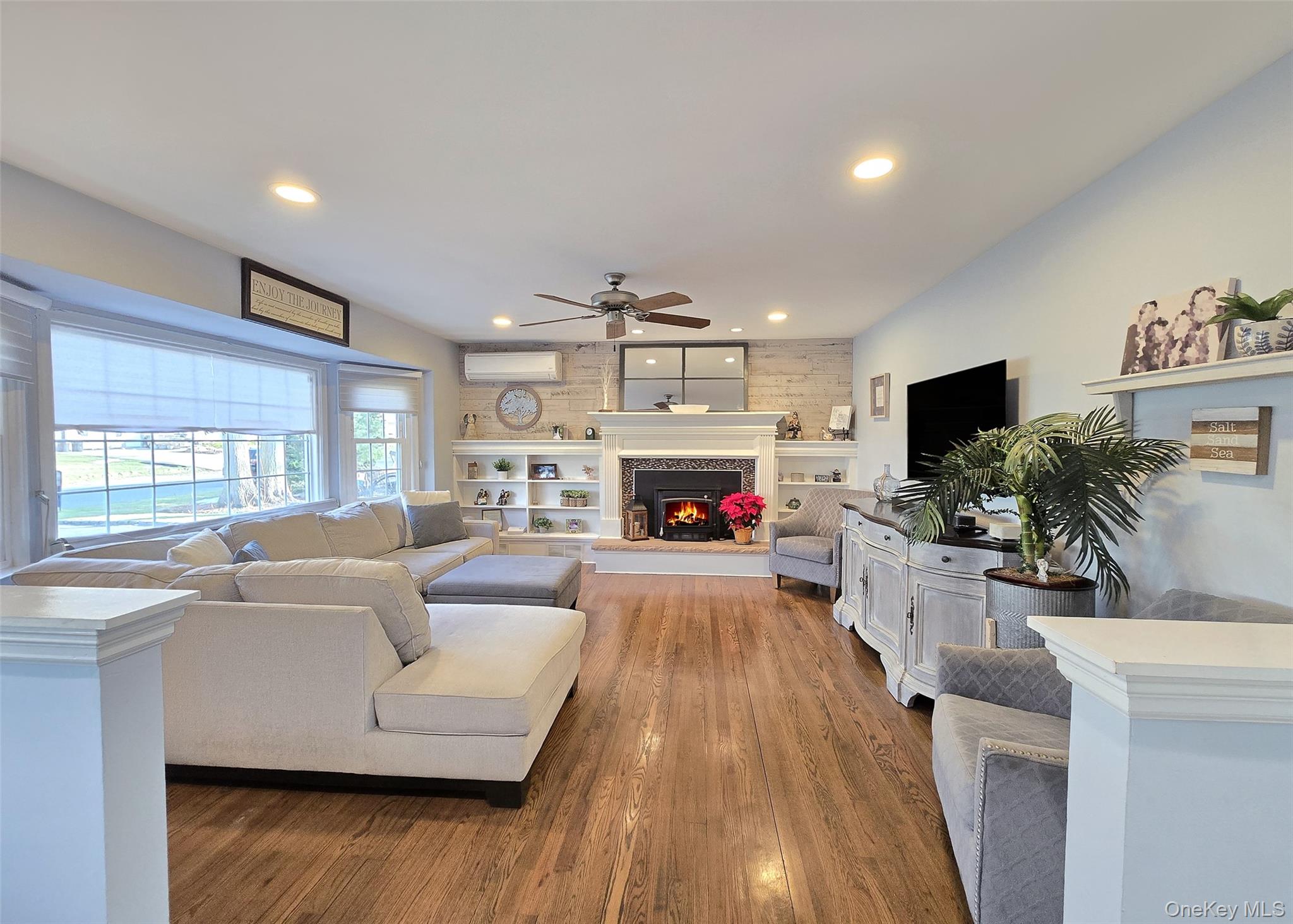 94 Clarendon Road Ronkonkoma, NY 11779 - Photo 2 of 31 a living room with furniture a flat screen tv and a fireplace
