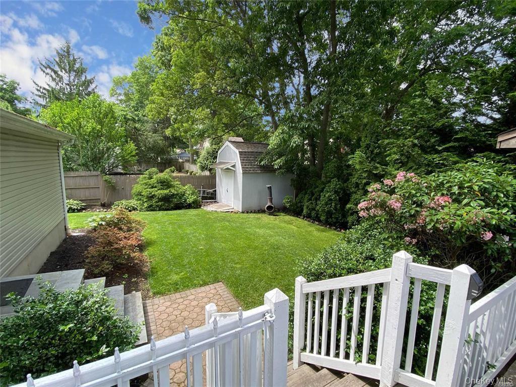 94 Clarendon Road Ronkonkoma, NY 11779 - Photo 24 of 31 a view of yard with small plants and trees