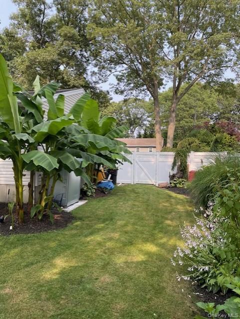 94 Clarendon Road Ronkonkoma, NY 11779 - Photo 30 of 31 a backyard of a house with lots of green space