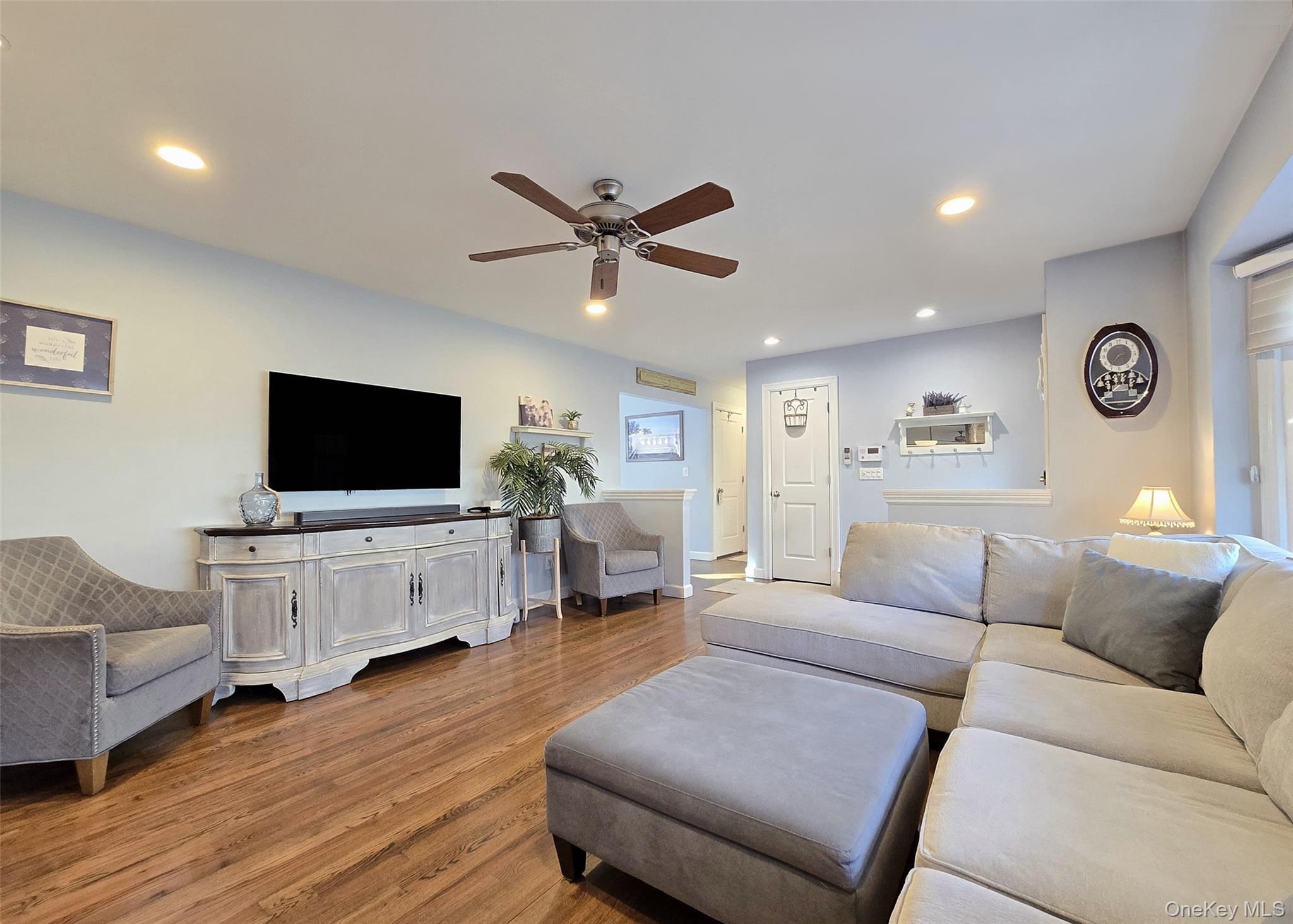 94 Clarendon Road Ronkonkoma, NY 11779 - Photo 3 of 31 a living room with furniture and a flat screen tv