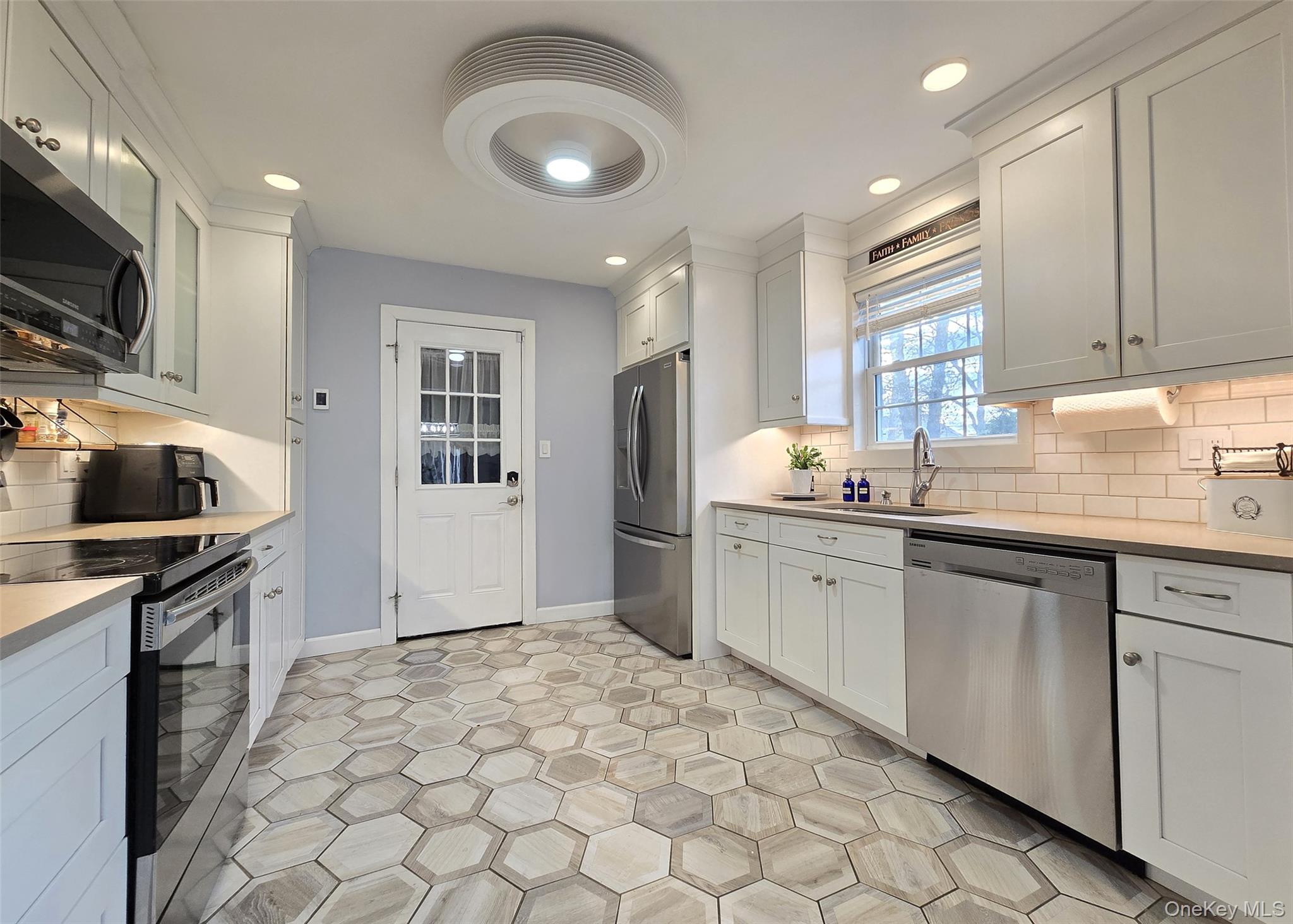 94 Clarendon Road Ronkonkoma, NY 11779 - Photo 6 of 31 a kitchen with a sink cabinets and window
