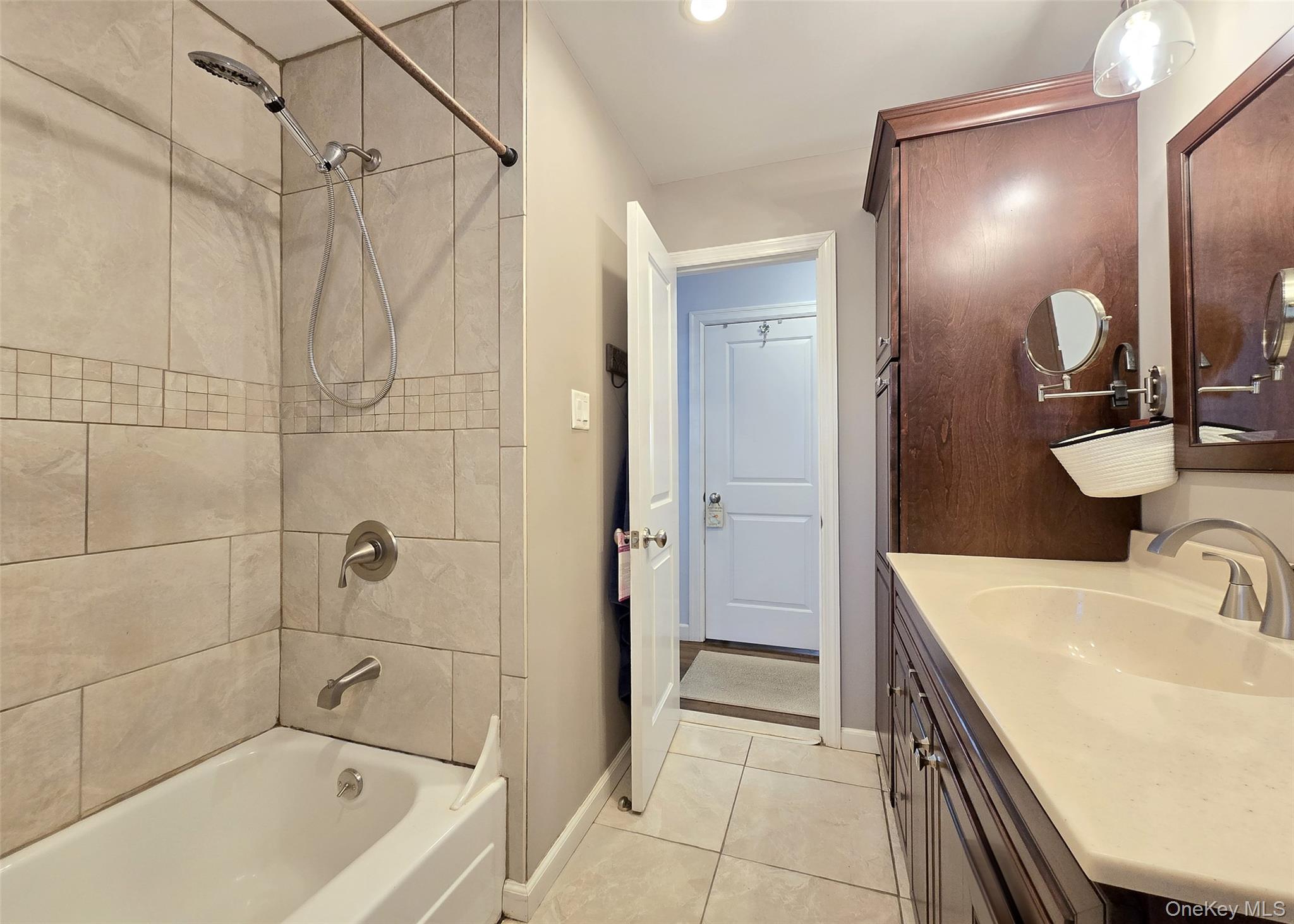94 Clarendon Road Ronkonkoma, NY 11779 - Photo 9 of 31 a bathroom with a tub sink shower and mirror