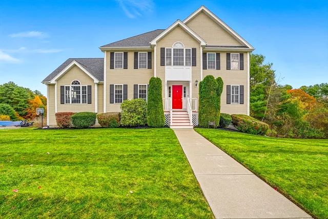 a front view of a house with a yard