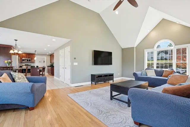 a living room with furniture wooden floor and a flat screen tv