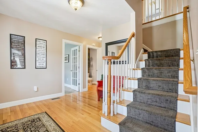 a front view of a house with wooden floor and stairs