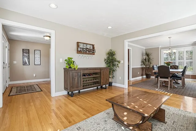 a living room with furniture a wooden floor and next to a window