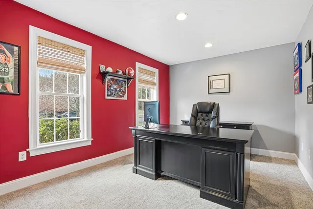 a view of a workspace with furniture and windows