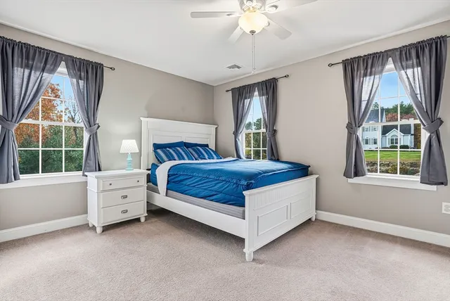 a bedroom with a bed and a large window