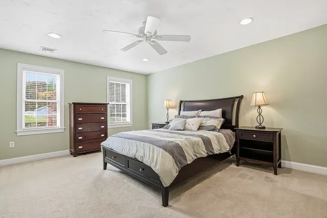 a bedroom with a bed a dresser and a window