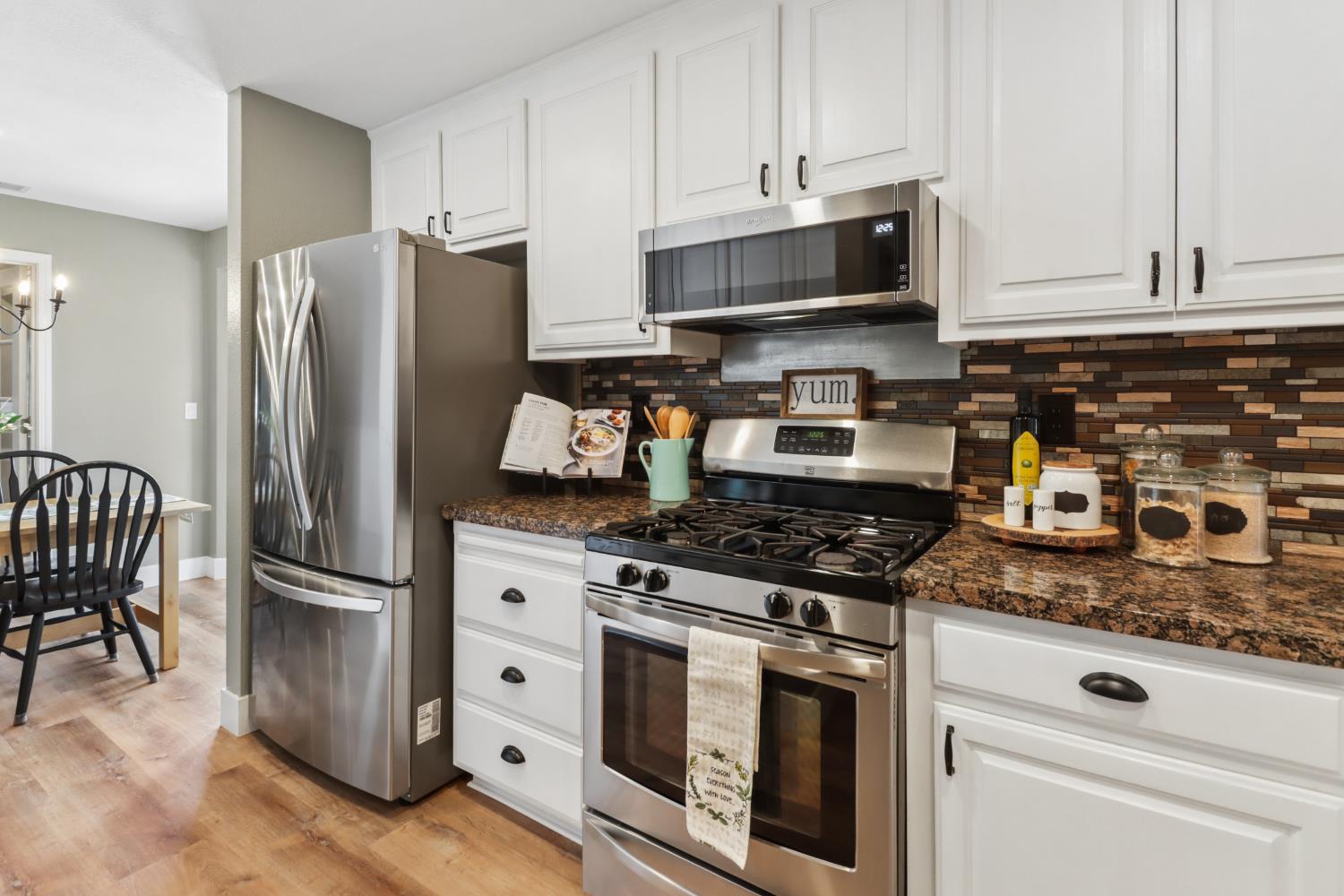 567 I Street Lincoln, CA 95648 - Photo 15 of 53 a kitchen with stainless steel appliances granite countertop a refrigerator stove and white cabinets
