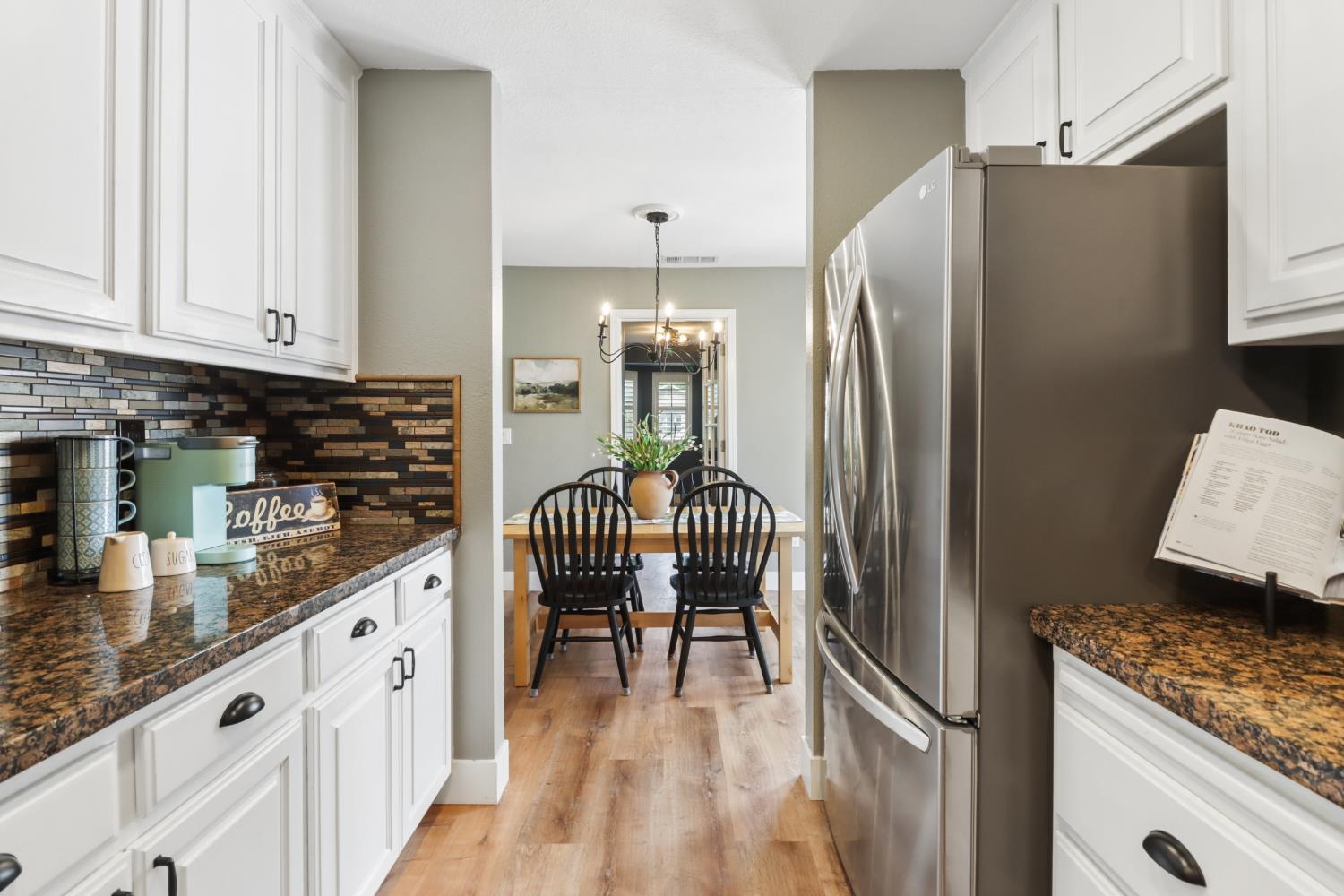 567 I Street Lincoln, CA 95648 - Photo 16 of 53 a kitchen with granite countertop a refrigerator and a sink