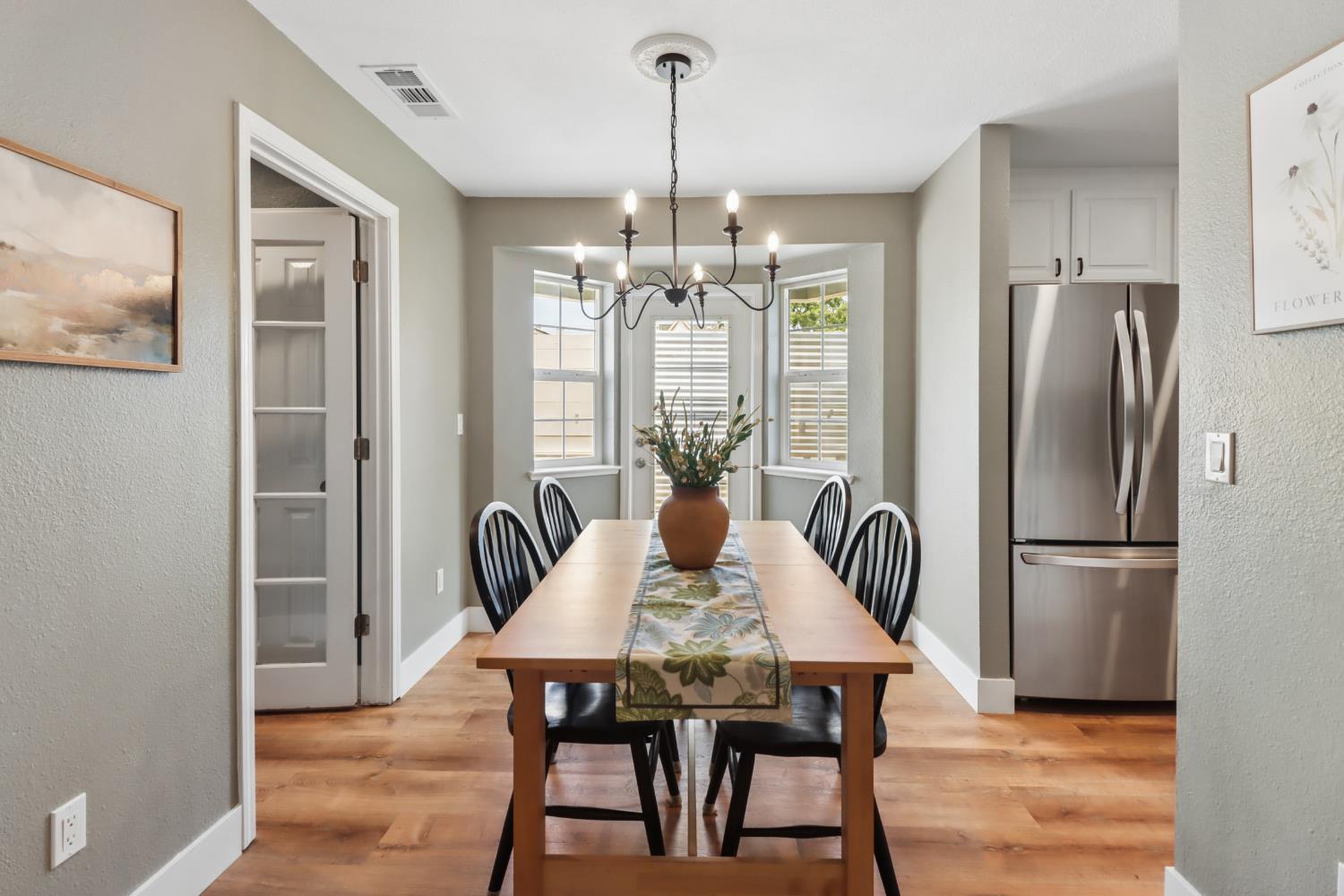 567 I Street Lincoln, CA 95648 - Photo 17 of 53 a dining room with furniture a chandelier and wooden floor