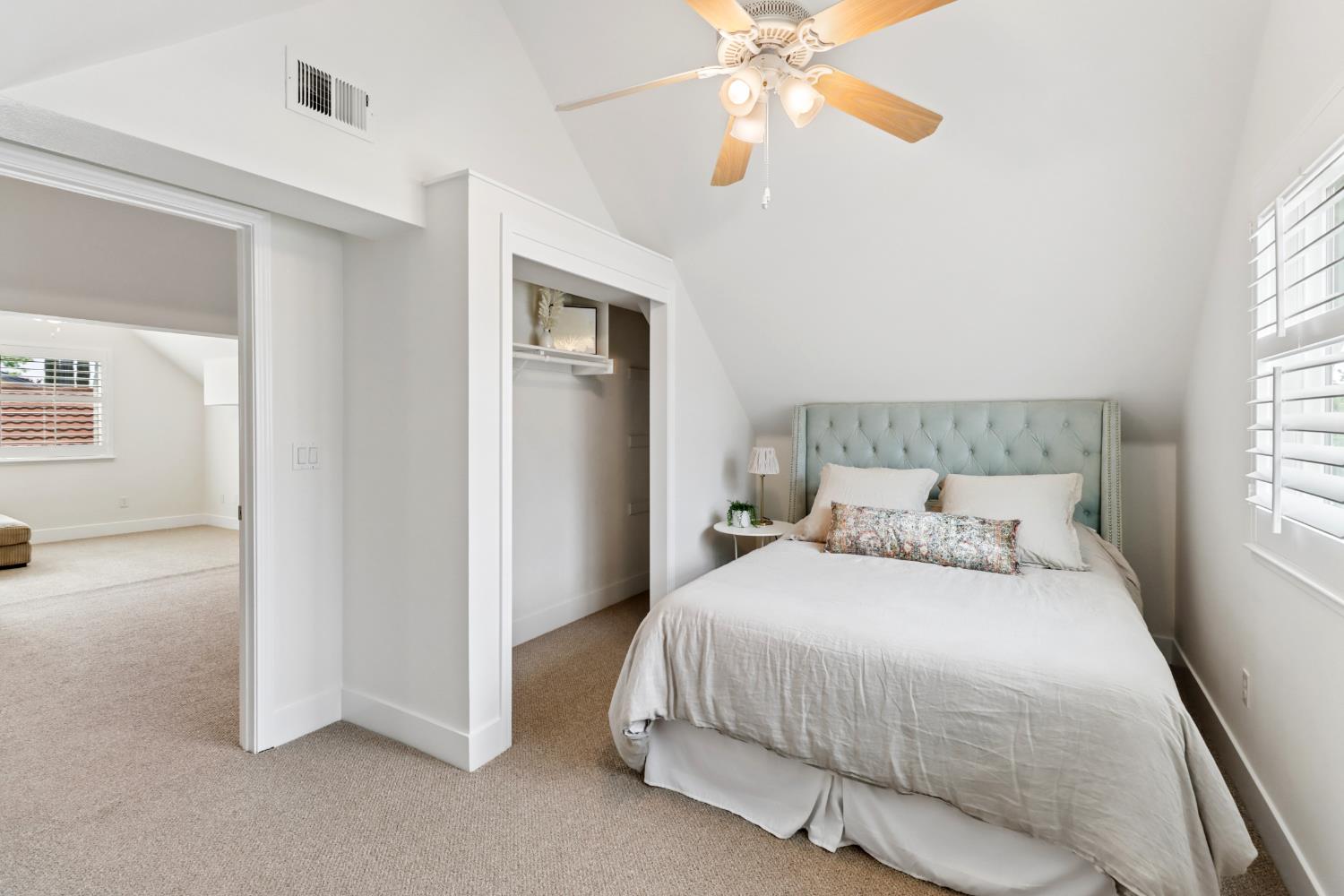 567 I Street Lincoln, CA 95648 - Photo 37 of 53 a bedroom with a bed and a chandelier