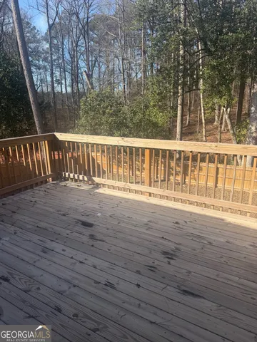 a view of deck house with wooden floor and fence