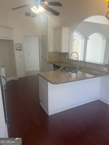 a kitchen with a sink and cabinets
