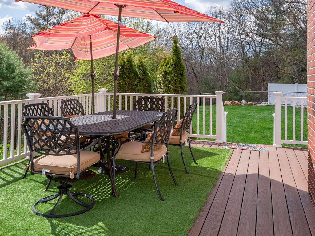 50 Sawmill Road Dudley, MA 01571 - Photo 11 of 40 a view of a deck with furniture and a backyard