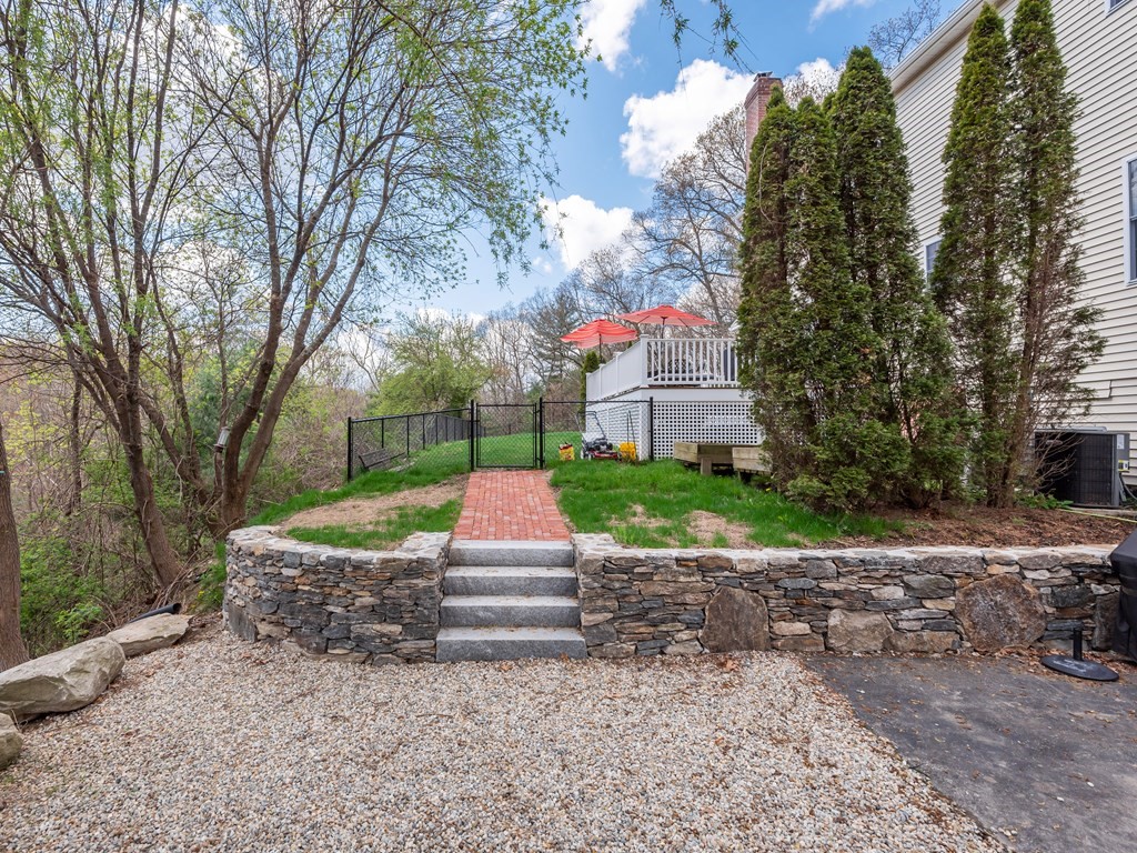 50 Sawmill Road Dudley, MA 01571 - Photo 5 of 40 a front view of a house with a yard and a garden