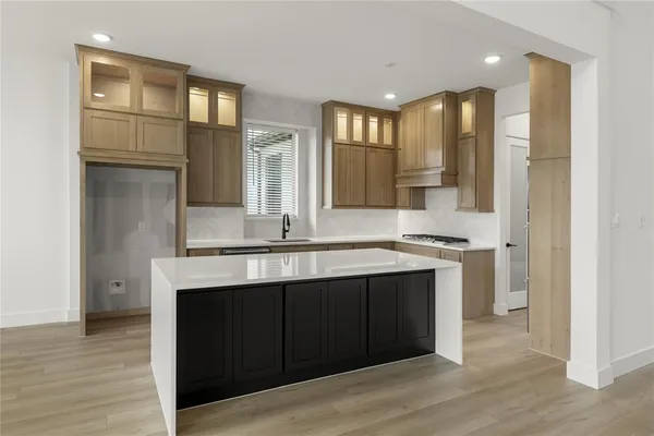 a kitchen with a sink and cabinets
