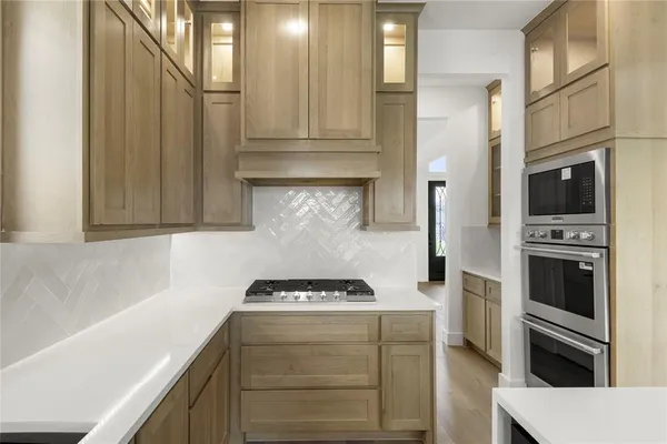a kitchen with a stove a sink and a refrigerator