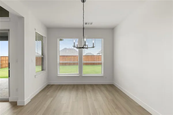 a kitchen with granite countertop a stove and a refrigerator