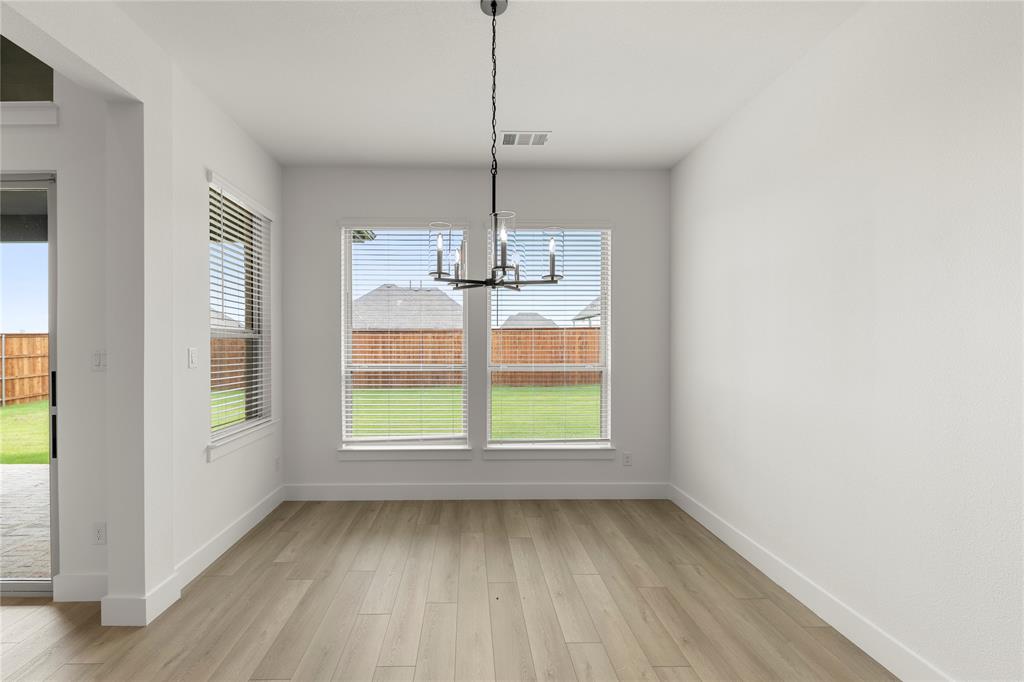 981 Georgetown Place Prosper, TX 75078 - Photo 13 of 30 a view of a room with window wooden floor and windows