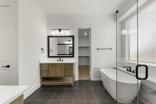 an empty room with wooden floor and a ceiling fan