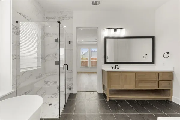 a bathroom with a bathtub and shower