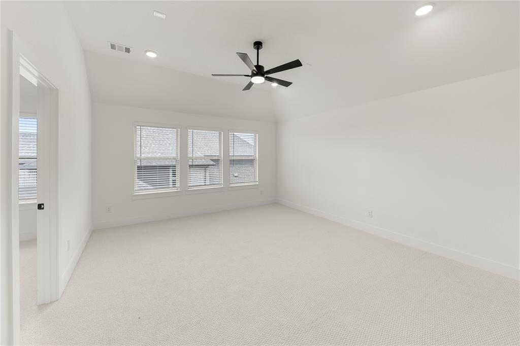 981 Georgetown Place Prosper, TX 75078 - Photo 22 of 30 an empty room with windows and ceiling fan